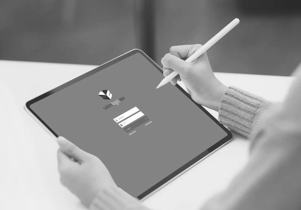 Hand using a stylus pen to navigate tablet