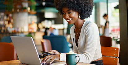 Woman using laptop in a coffee shop