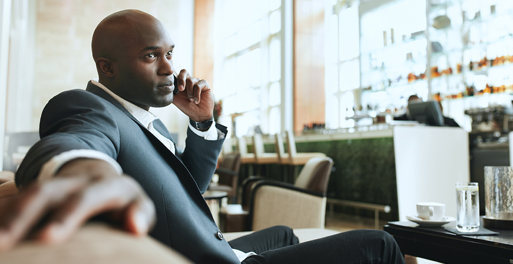 Man on phone while drinking coffee